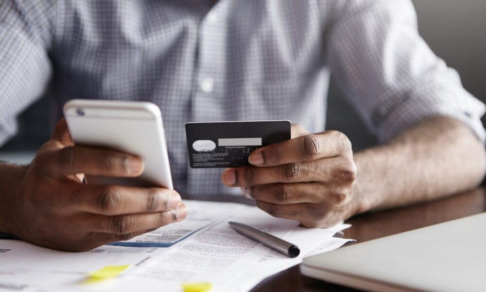 cropped-shot-african-american-male-paying-bill-restaurant-with-online-payment-technology_273609-9077